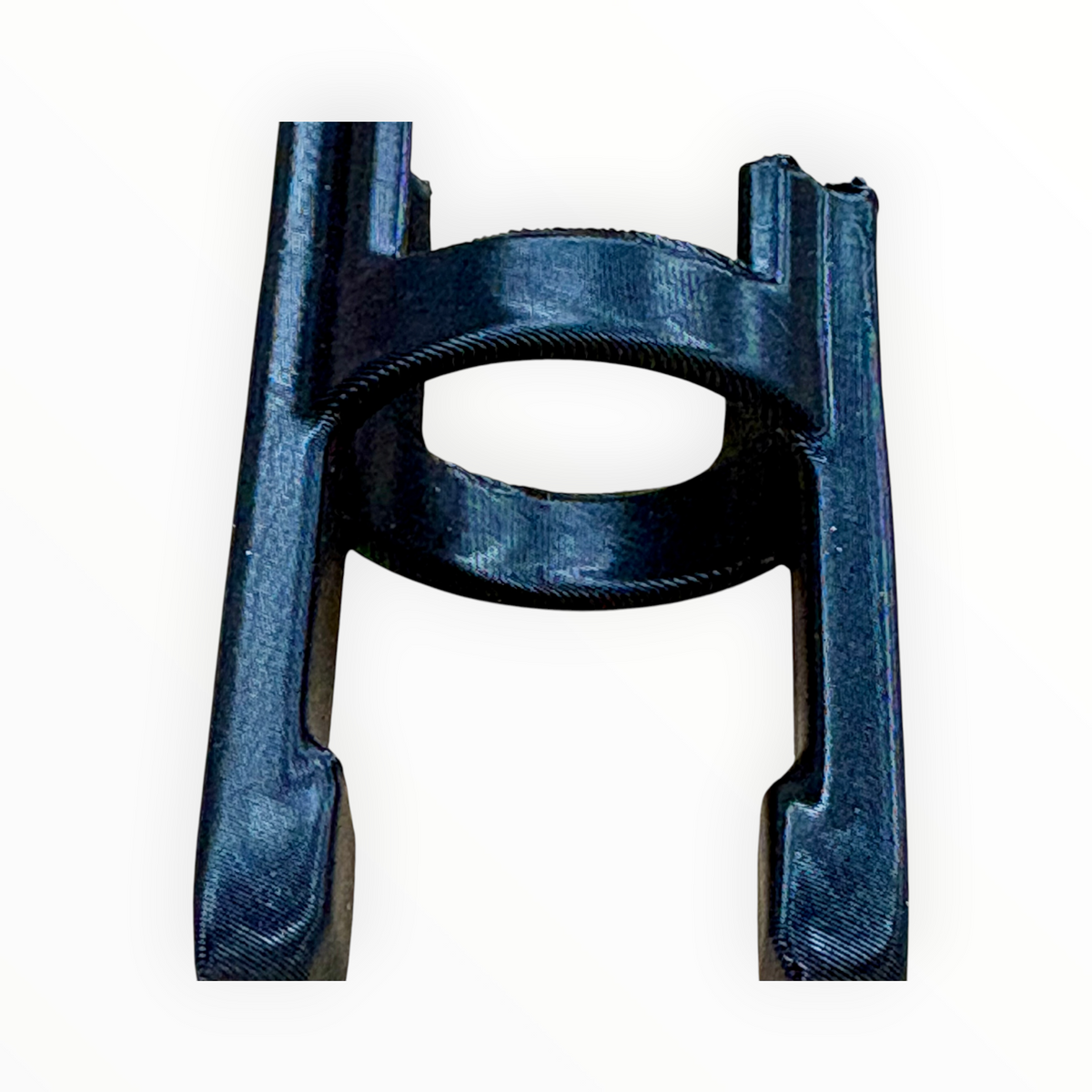 Straight-on view of the black M-Lifter Tab Trap showing its mounting ring and retaining legs.