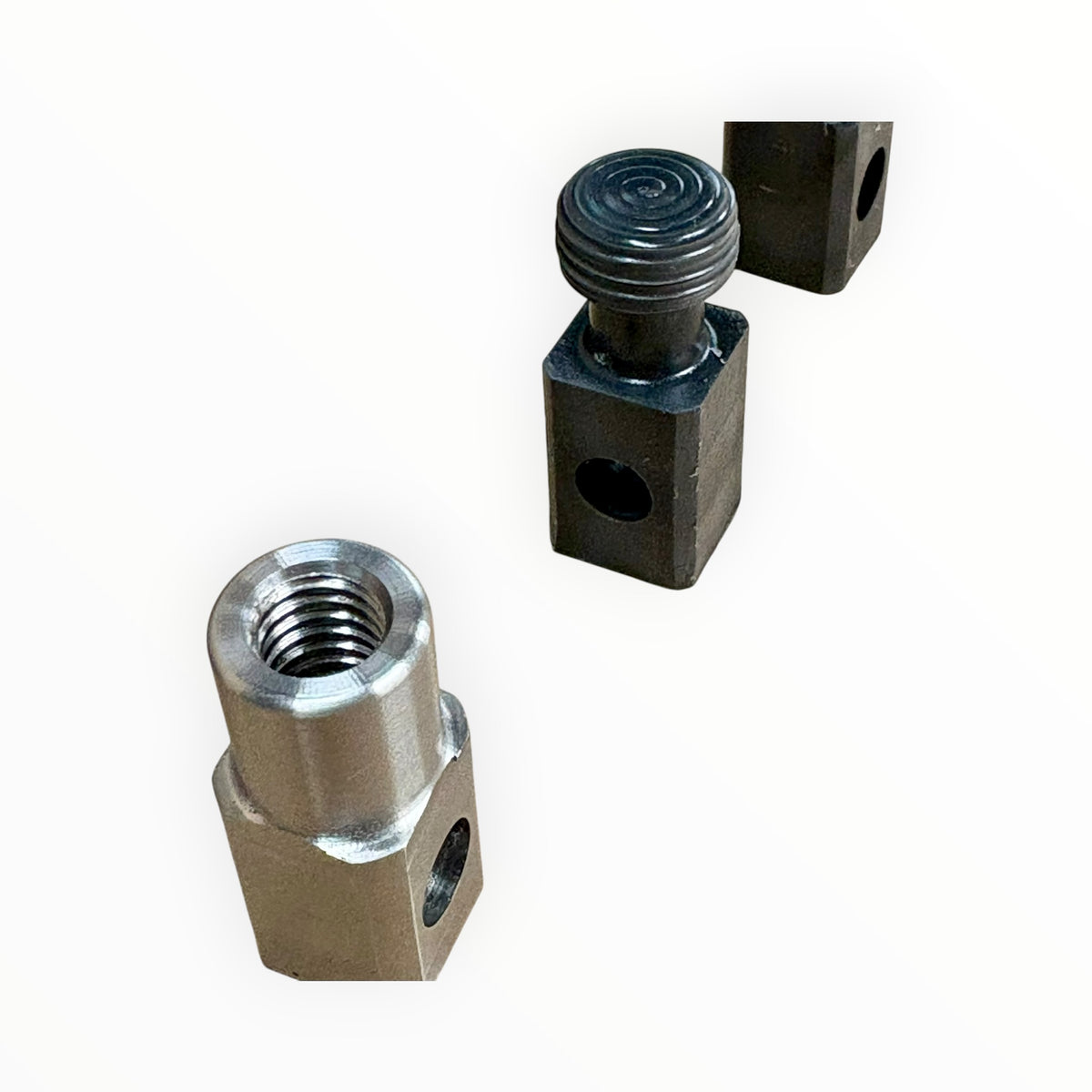 Close-up of threaded tab adapter and round cold glue tab with square drive bases.